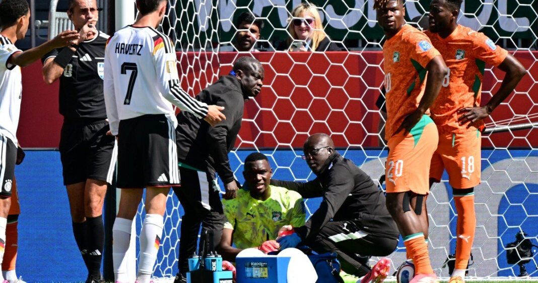 Arquero de fútbol sentado en el césped durante un partido